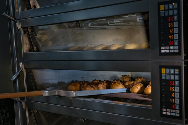 Artisan bread baking in a professional oven at a Berlin bakery, showcasing traditional baking techniques.